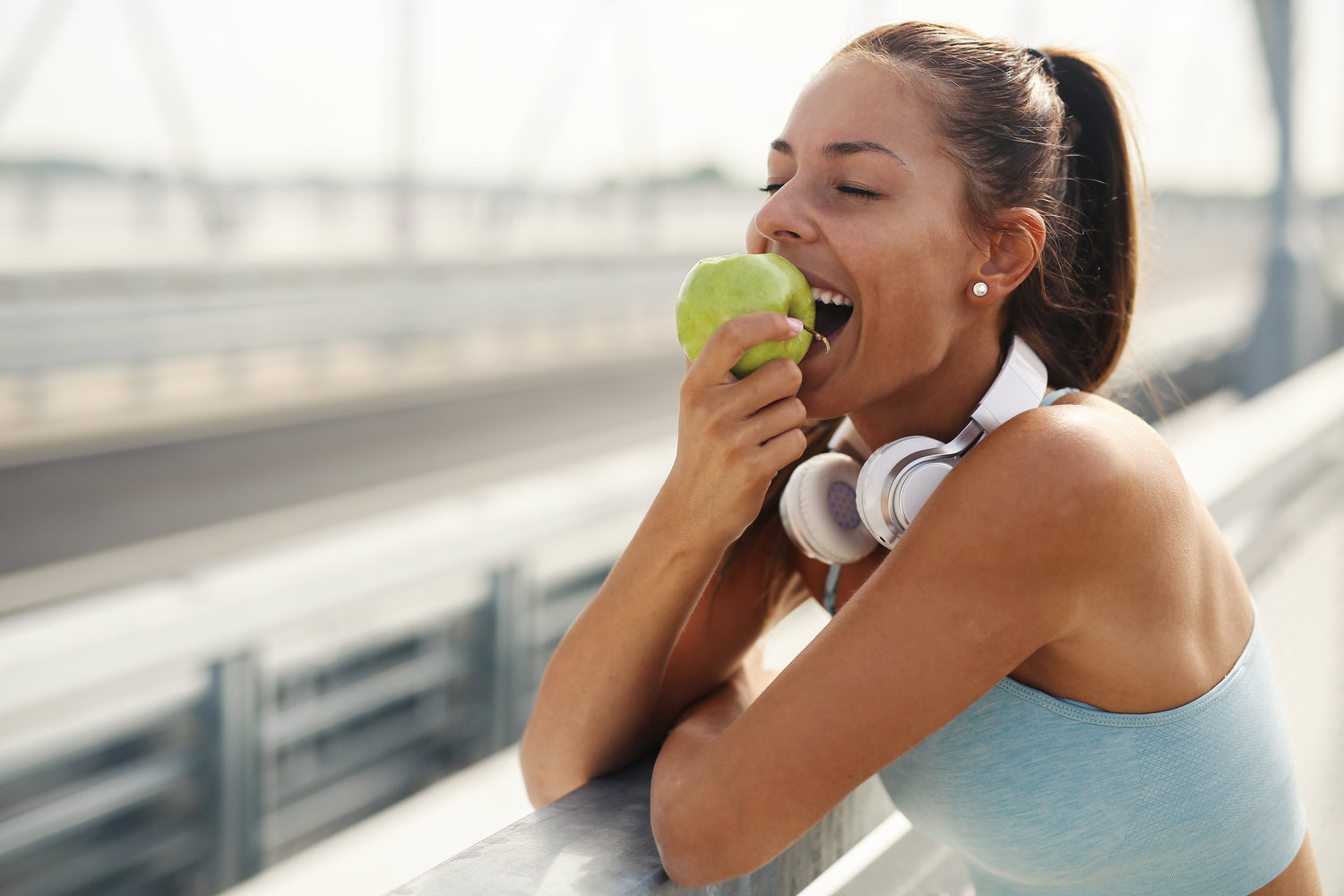 Healthy woman eating an apple, enjoying a nutritious snack.