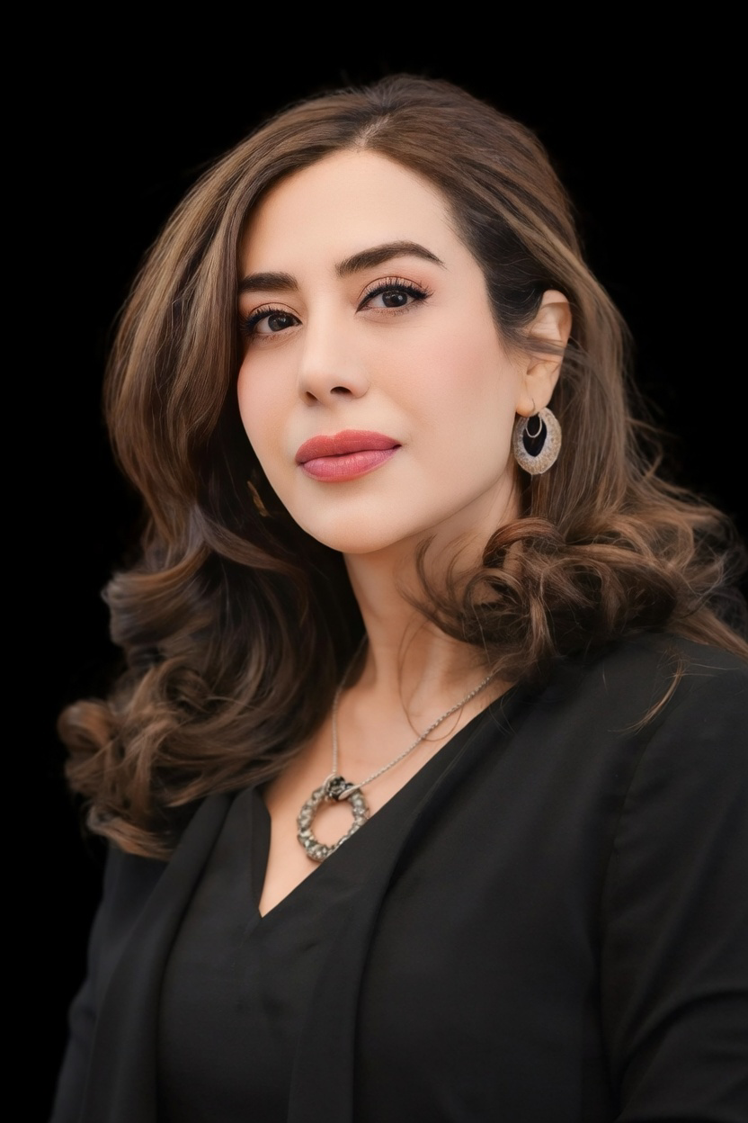 Woman with styled hair and makeup against a black background